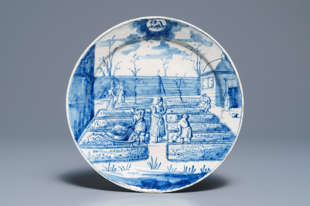 A Dutch Delft blue and white plate with peasants from the 'Zodiac' series, first quarter 18th C.