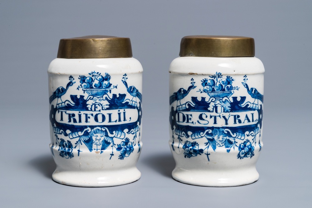 A pair of Dutch Delft blue and white drug jars with brass lids, 18th C.