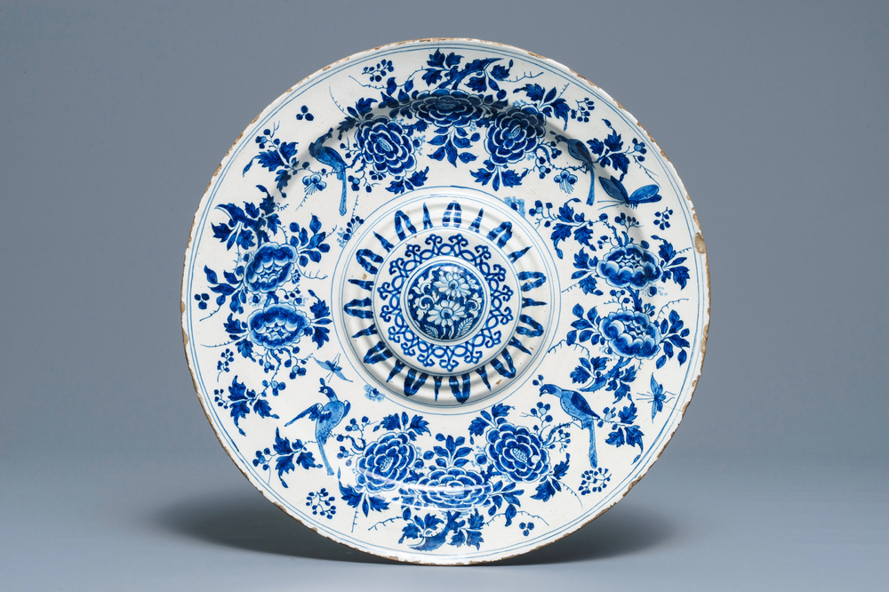 A large Dutch Delft blue and white salad dish with birds among flowers, late 17th C.