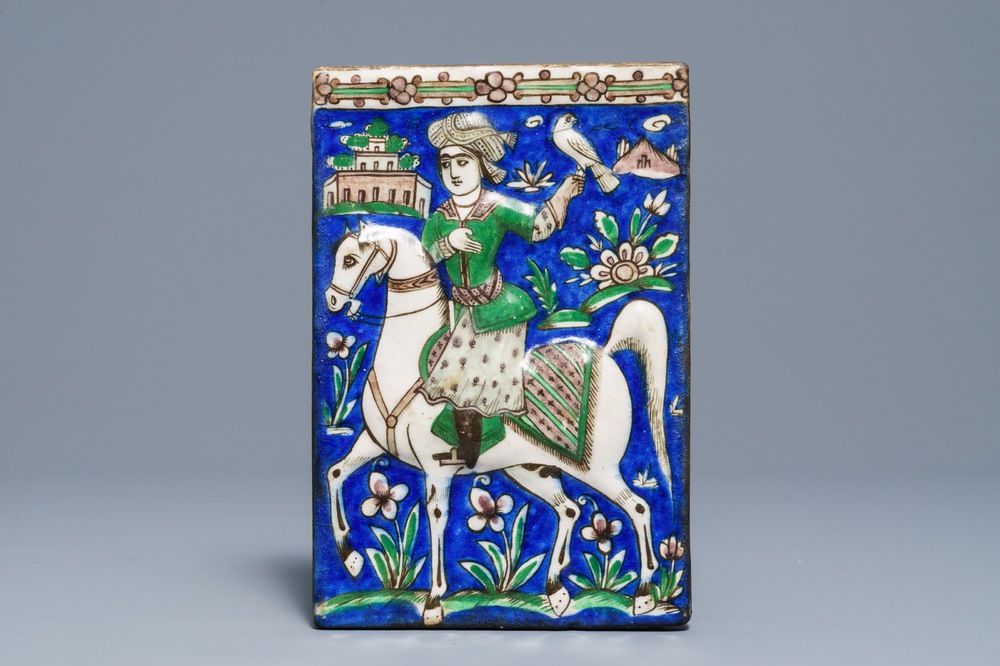 A rectangular moulded tile with a falconer, Qajar, Iran, 19th C.