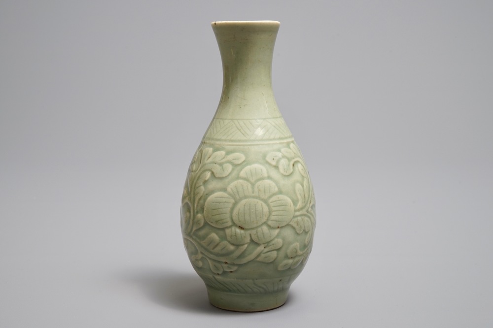 A Chinese relief-decorated celadon 'peony' vase, 18/19th C.