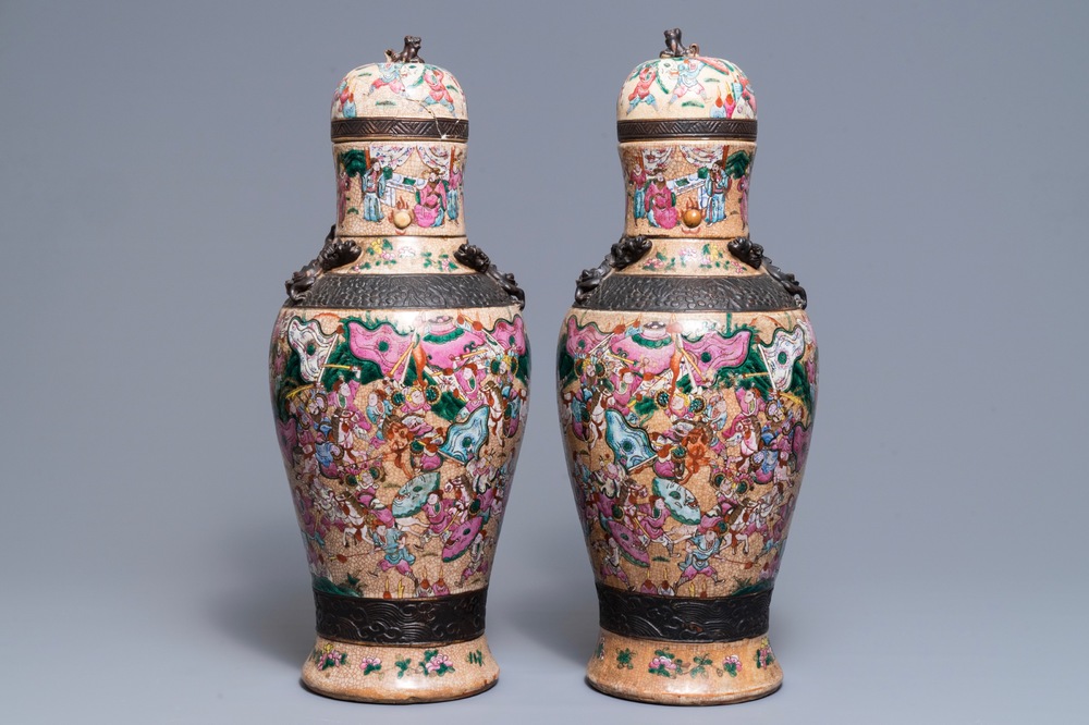 A pair of Chinese Nanking famille rose vases and covers, 19th C.