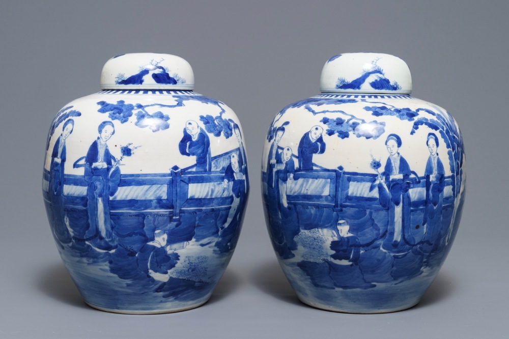 A pair of Chinese blue and white jars and covers with figures in a garden, Kangxi mark, 19th C.