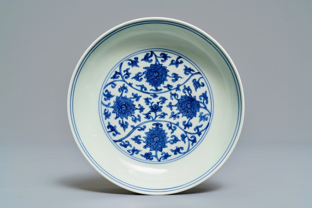 Une assiette en porcelaine de Chine bleu et blanc aux rinceaux de lotus, marque et &eacute;poque de Wanli