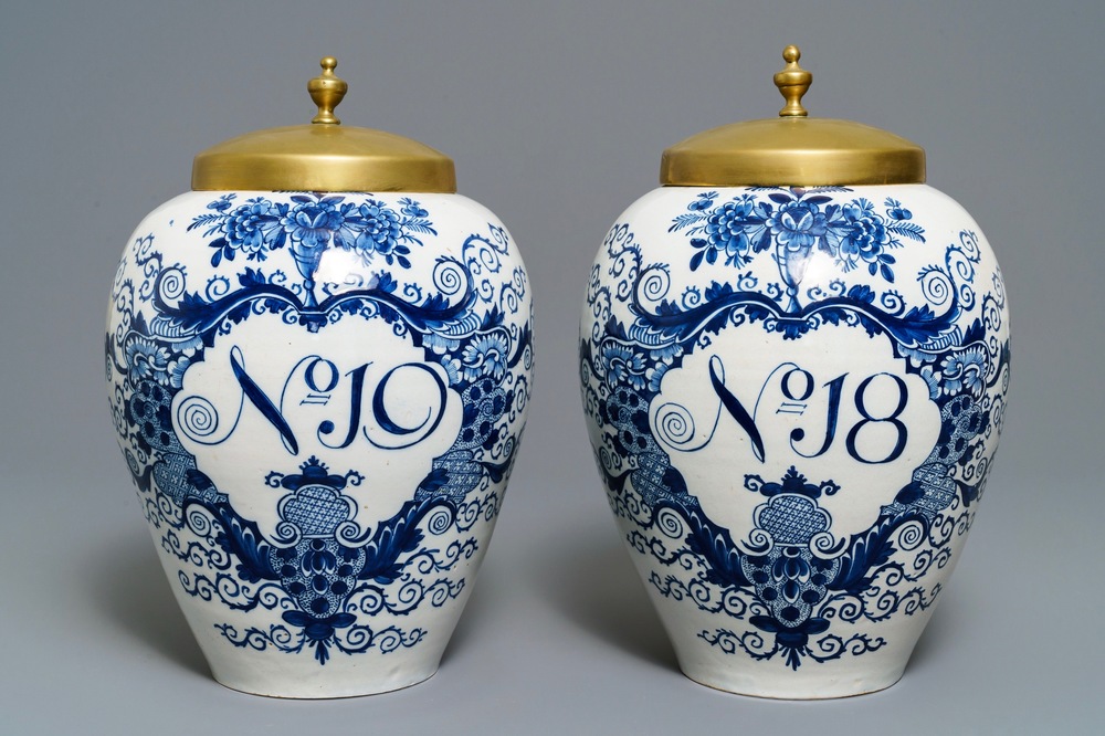 A pair of large Dutch Delft blue and white tobacco jars with brass covers, 18th C.