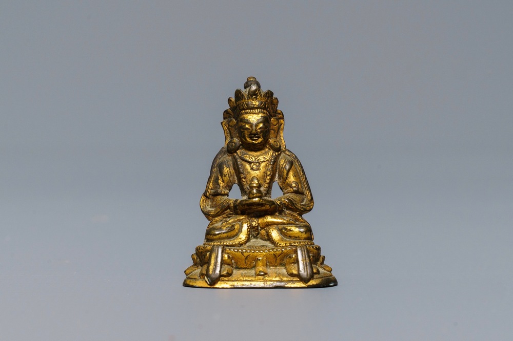 A Sino-Tibetan gilt bronze miniature figure of Buddha, 16/17th C.