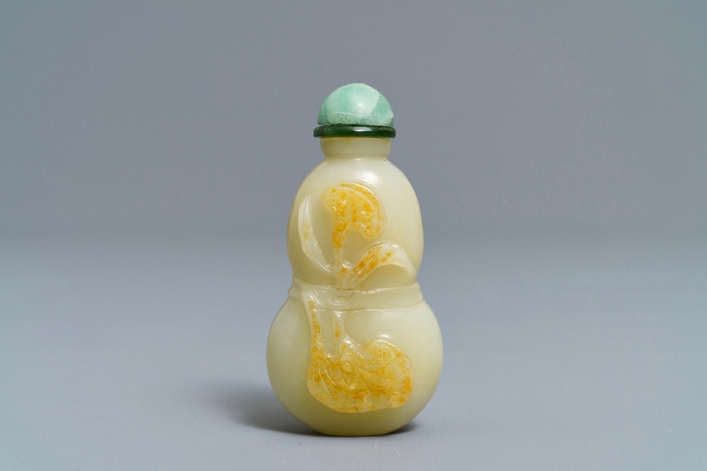 A Chinese pale celadon and russet jade double gourd snuff bottle, 19th C.