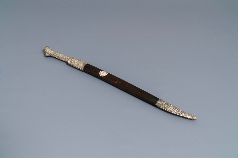 An Ottoman silver-mounted Damascus steel 'yatagan' sword in its leather sheath, Turkey, 19th C.