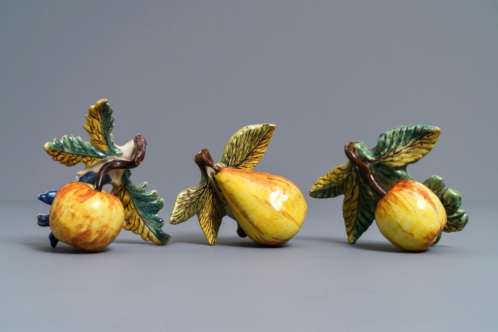 Two polychrome Dutch Delft models of apples and one of a pear, 18th C.