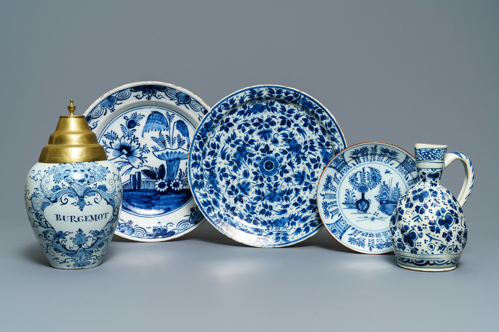 A Dutch Delft blue and white tobacco jar, a jug and three dishes, 18th C.