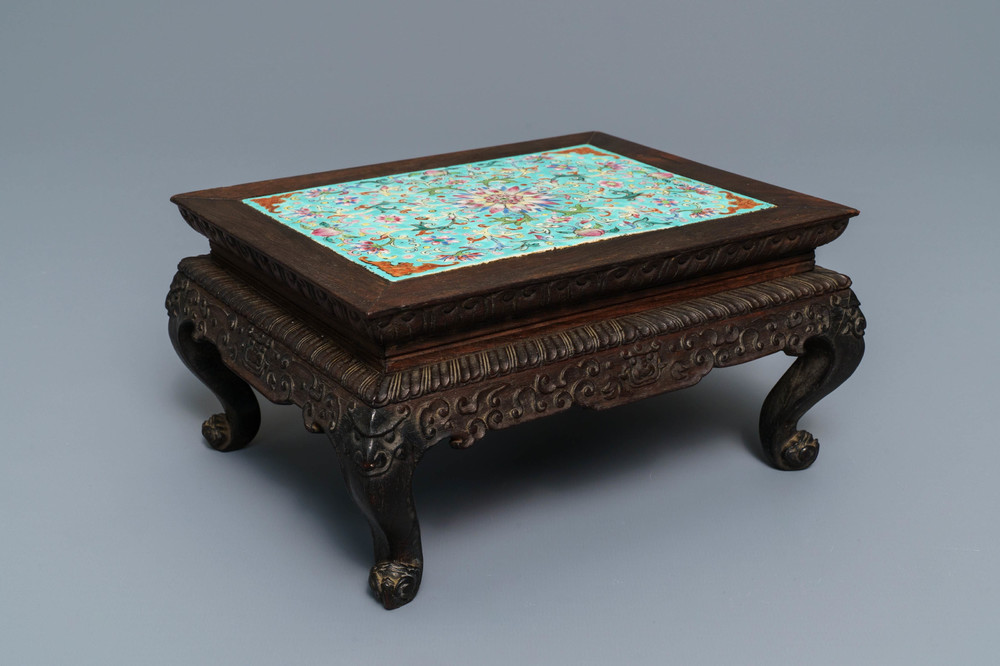 A Chinese carved wooden stand with famille rose plaque, 19th C.