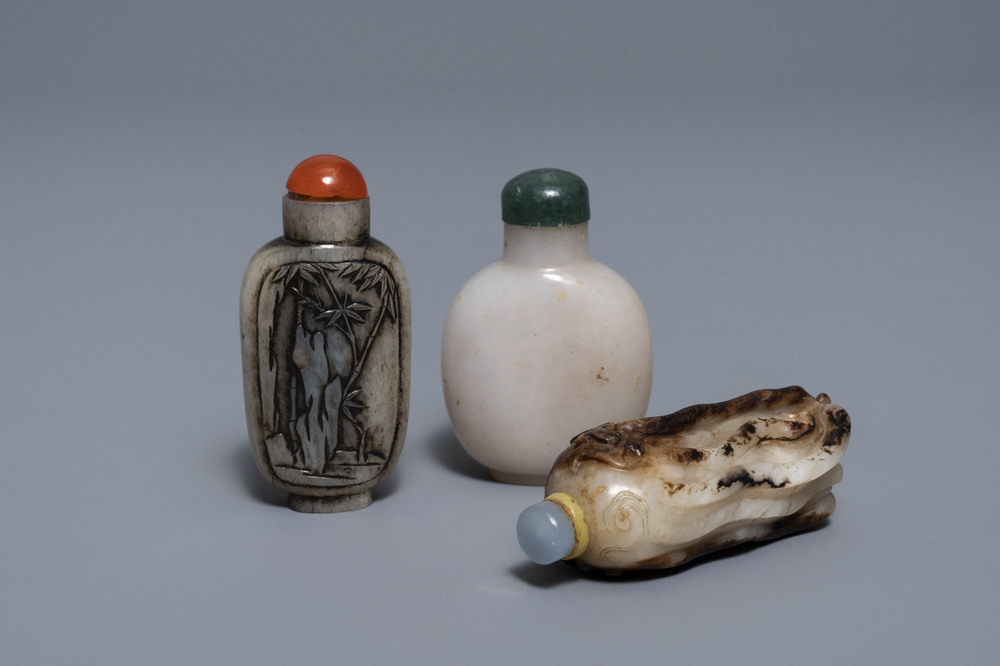 Three Chinese greyish white and black and white jade snuff bottles, 19/20th C.