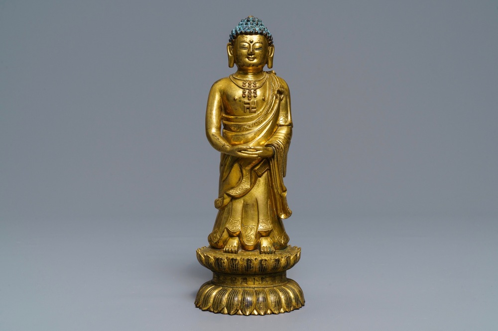 An inscribed Chinese gilt bronze figure of Buddha standing, Qianlong