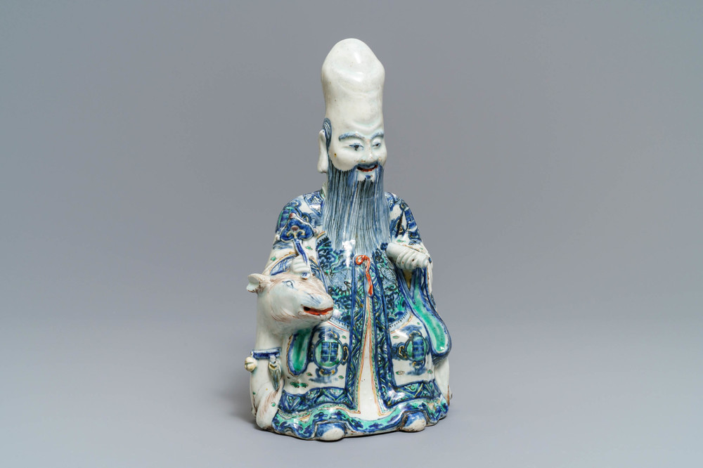 A rare Chinese wucai figure of Shoulao seated on a deer, Wanli