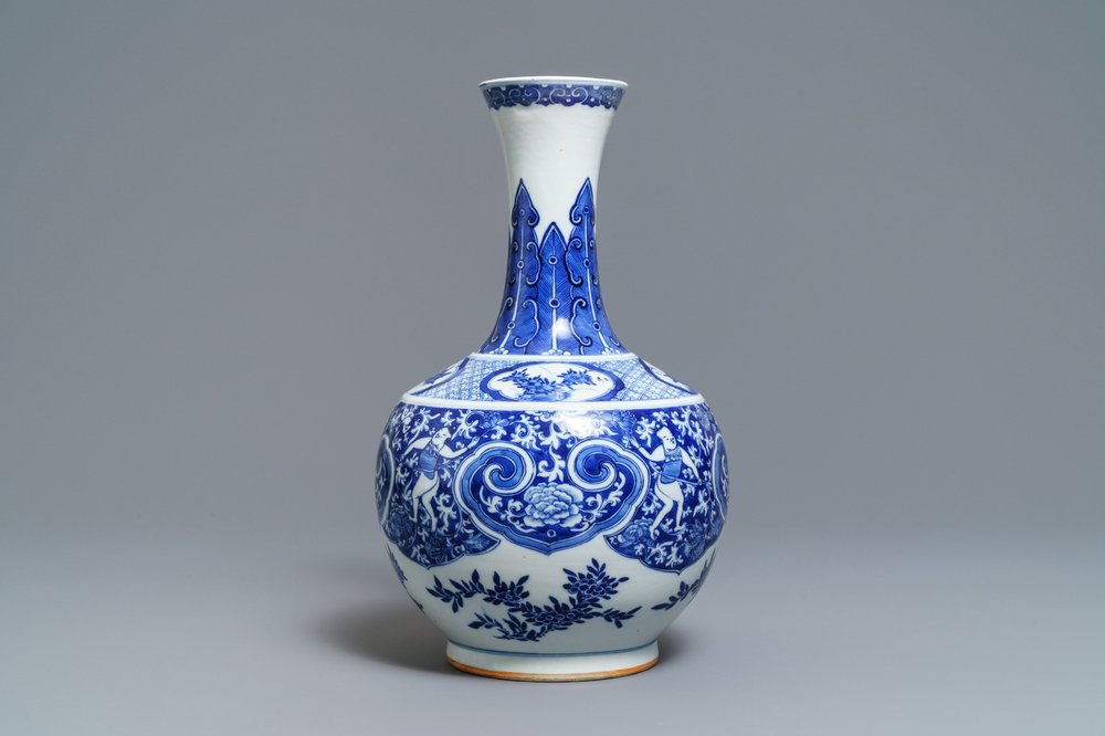 A Chinese blue and white bottle vase with dancers on a floral ground, 19th C.