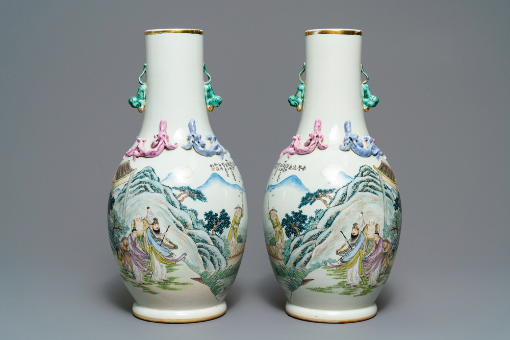 A pair of Chinese famille rose vases with figures in a landscape, 19/20th C.