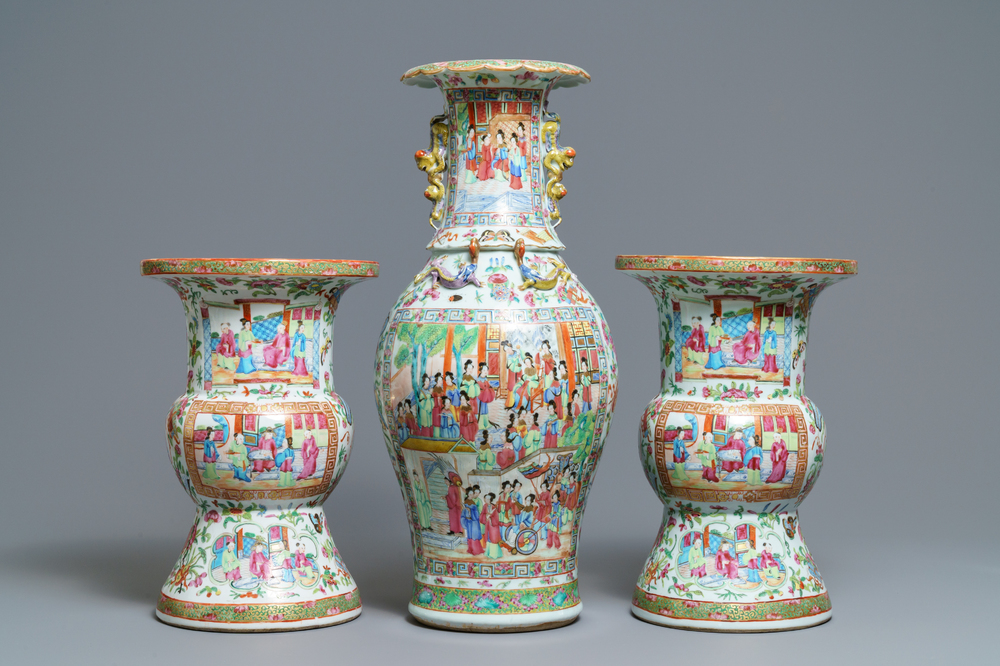 A pair of Chinese Canton famille rose spittoons and a vase, 19th C.