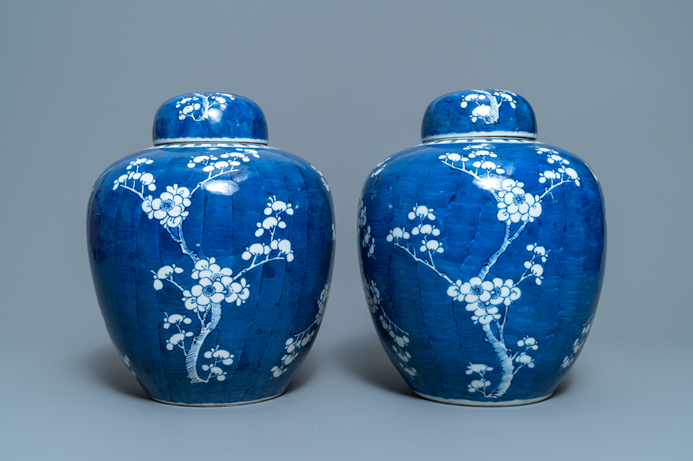 A pair of Chinese blue and white 'prunus on cracked ice' jars and covers, 19th C.