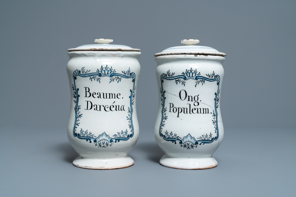 A pair of blue and white French faience albarello-type drug jars and covers, 2nd half 18th C.