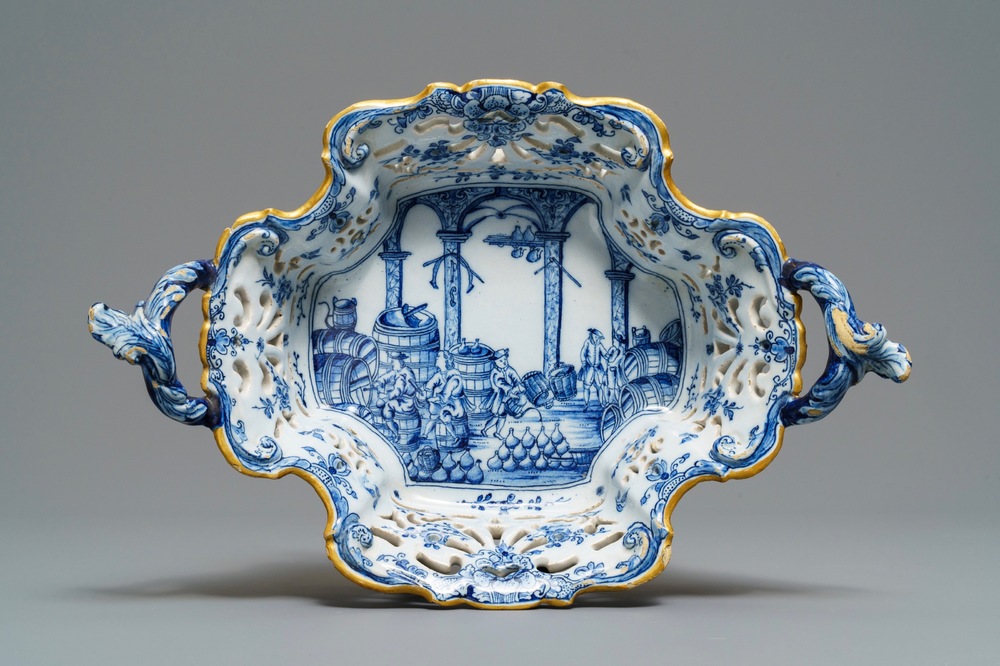 A reticulated Dutch Delft blue and white basket with a view on a wine cellar, 18th C.