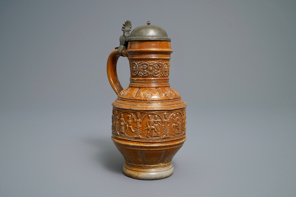 A 'Peasants dance' stoneware jug with pewter lid, Raeren, dated 1578