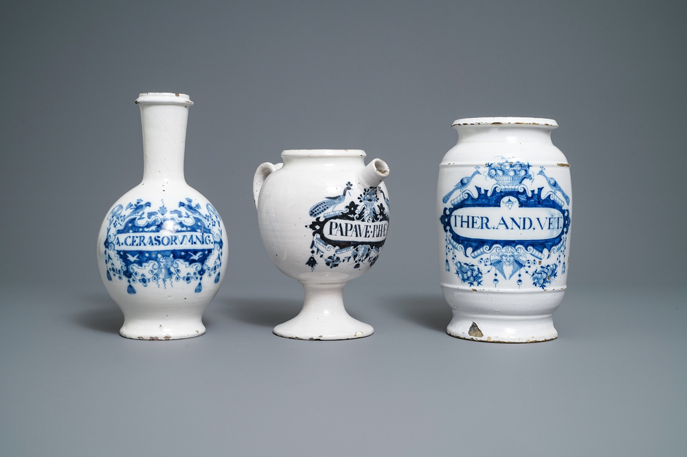 A large Dutch Delft blue and white albarello, a wet drug jar and a Brussels faience bottle, 18th C.