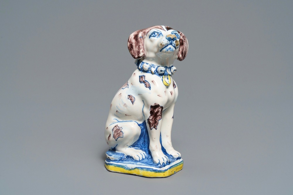 A polychrome Dutch Delft model of a dog, early 18th C.