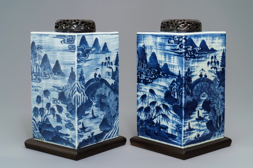 A pair of tall Chinese blue and white tea caddies with landscapes, 19th C.