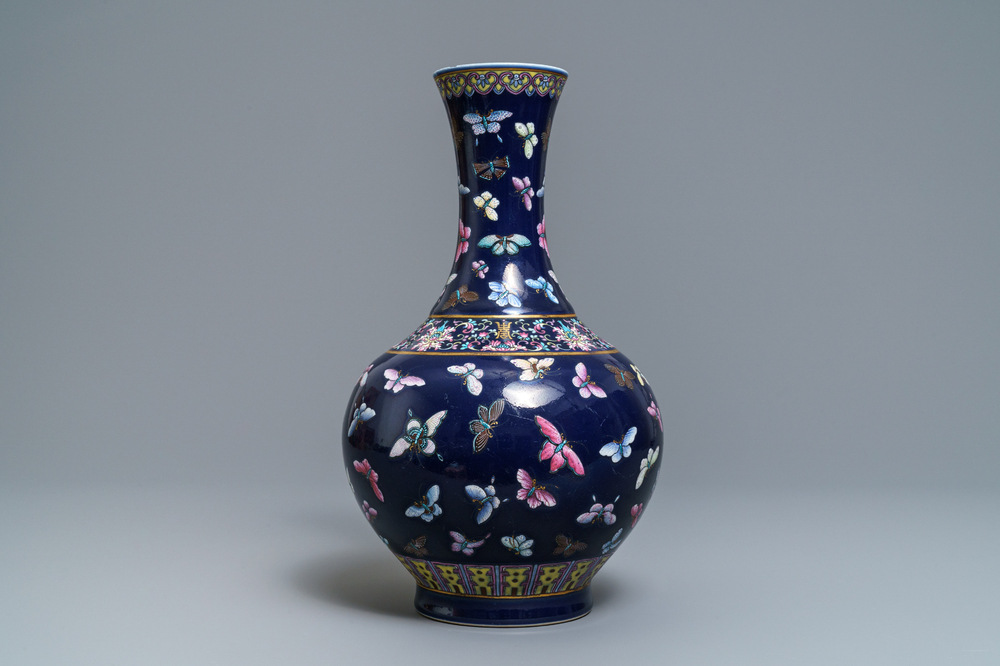 A Chinese blue-ground bottle vase with overglaze butterfly design, Guangxu mark, 19/20th C.