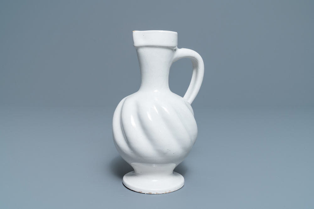 A white Dutch Delft gadrooned jug, 17th C.