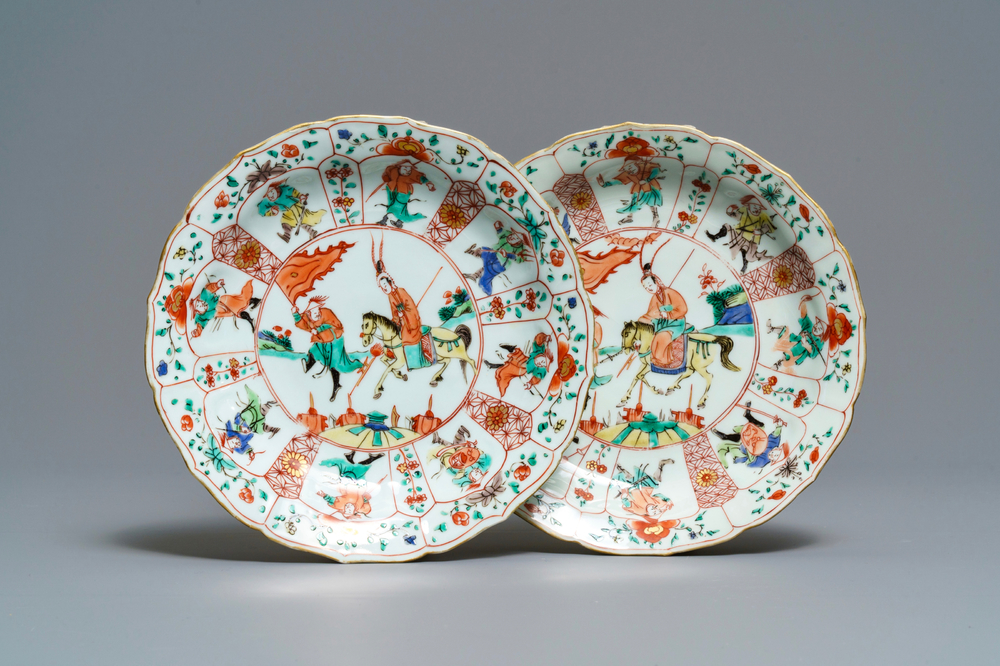 A pair of Chinese famille verte lotus-moulded 'Mu Guiying' plates, Kangxi