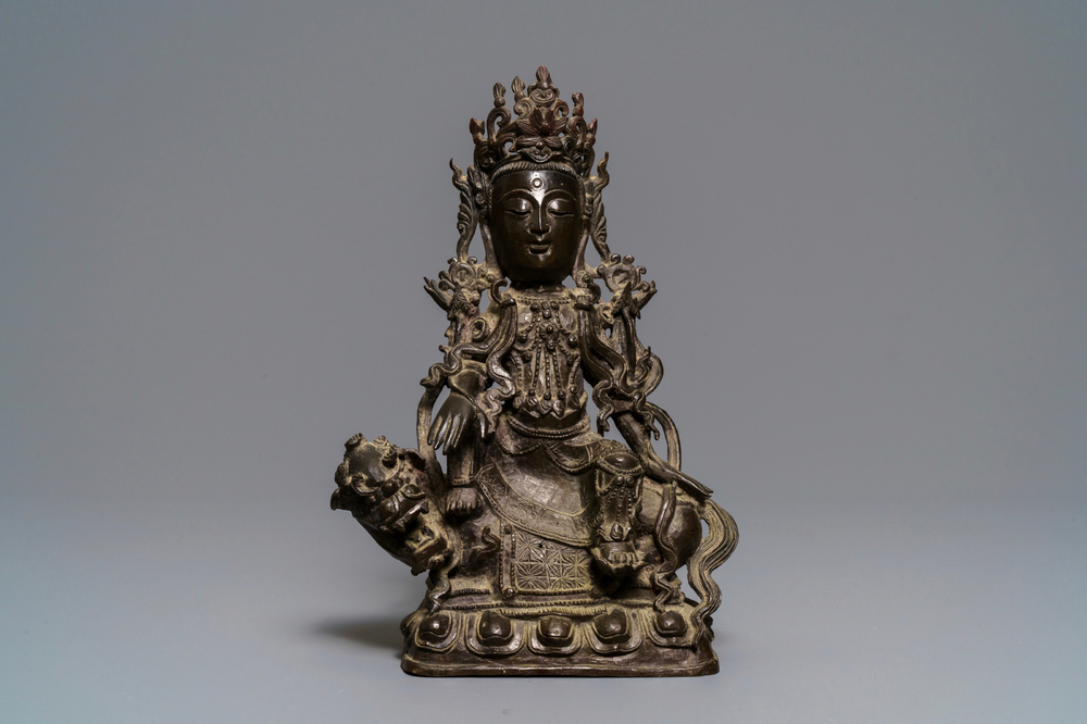 A Chinese bronze figure of Guanyin on a qilin, Ming