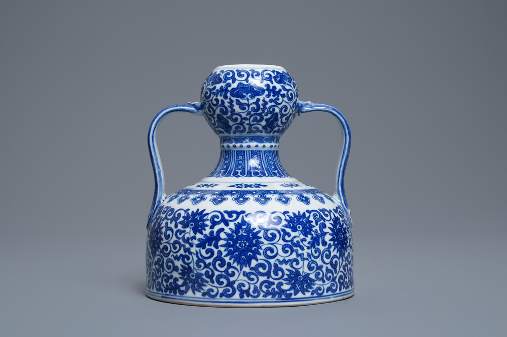 A Chinese blue and white two-handled 'lotus scroll' jug, Qianlong mark, 19/20th C.