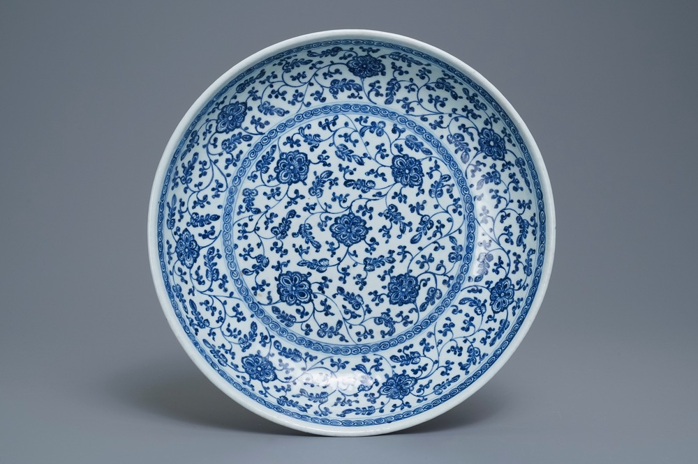 Un plat en porcelaine de Chine bleu et blanc &agrave; d&eacute;cor de rinceaux floraux de style Ming, Qianlong