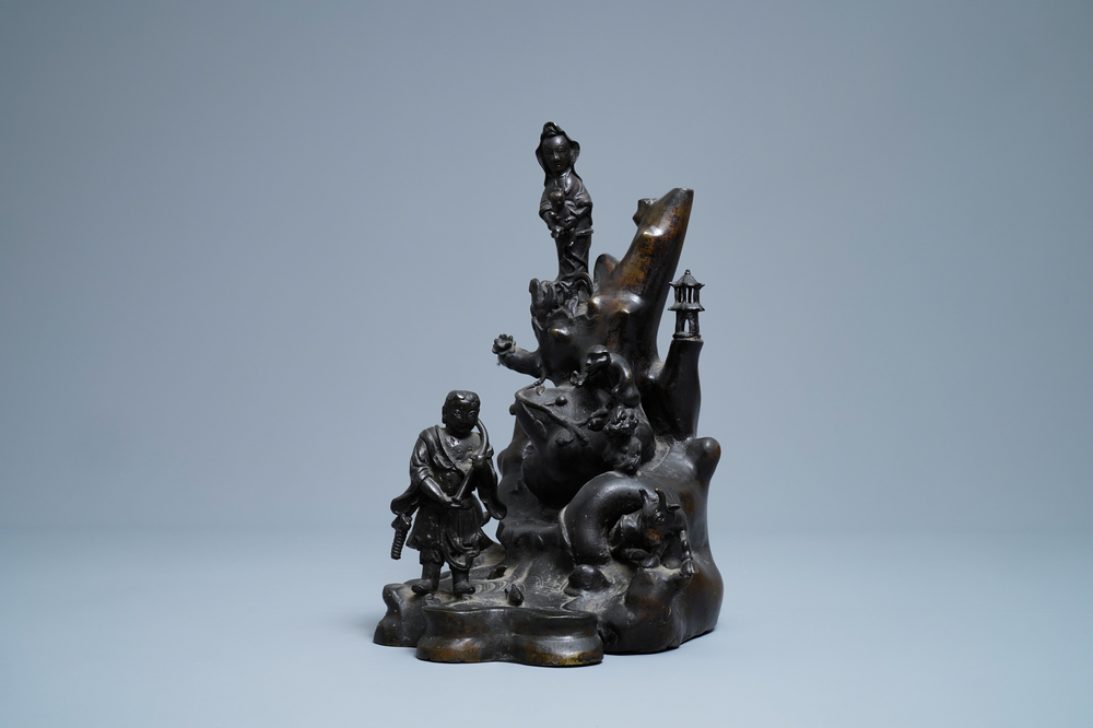 A large Chinese bronze group with Guanyin with child on a rock, Ming