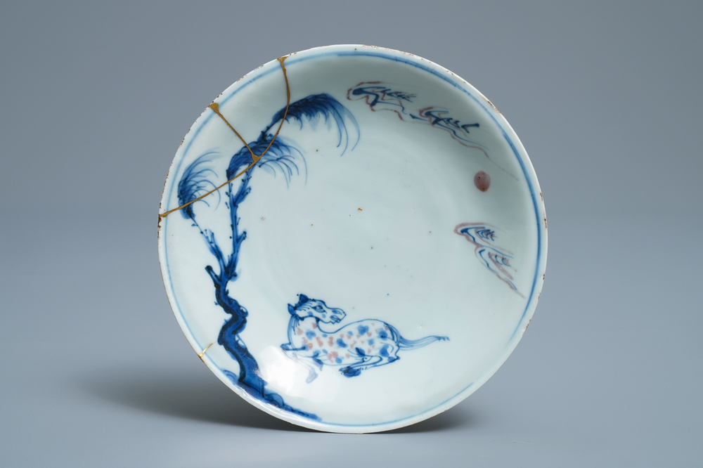 A Chinese blue, white and underglaze red plate with a horse and kintsugi repair, Tianqi