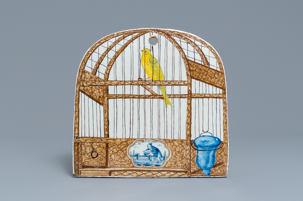 Une plaque en fa&iuml;ence de Delft polychrome &agrave; d&eacute;cor trompe l'oeil d'un cage &agrave; oiseaux, 18&egrave;me