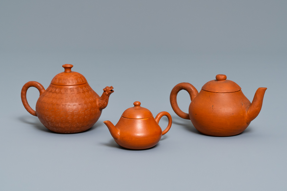 Three Chinese Yixing stoneware teapots and covers, impressed marks, 18/19th C.