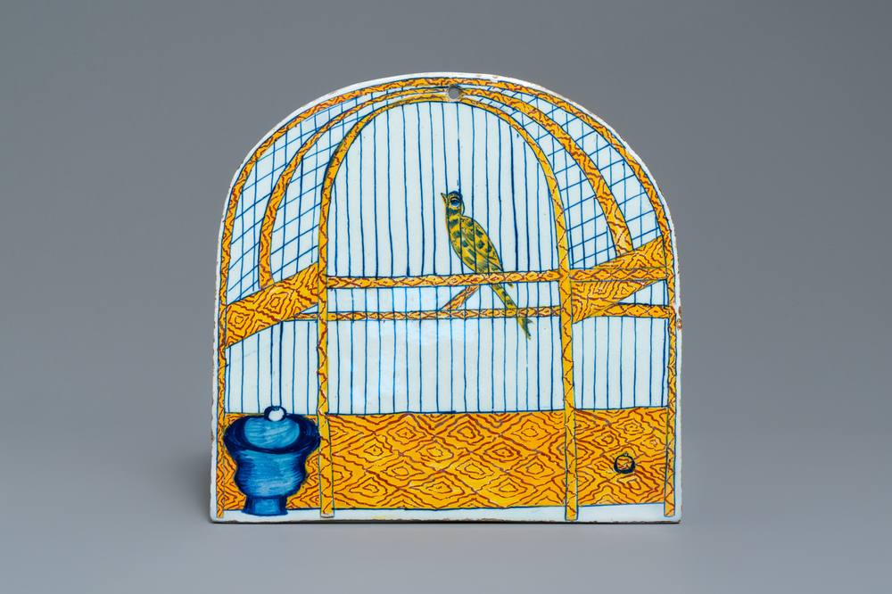 Une plaque en fa&iuml;ence de Delft polychrome &agrave; d&eacute;cor trompe l'oeil d'un cage &agrave; oiseaux, 18&egrave;me