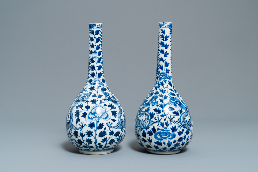 A pair of Chinese blue and white bottle vases with dragons, 19th C.