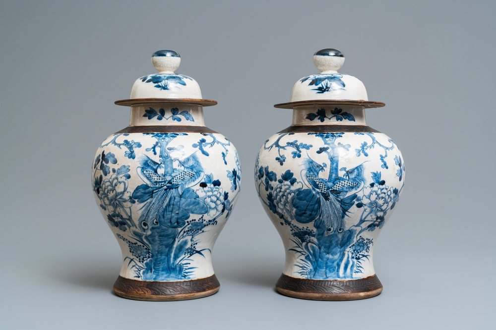 A pair of Chinese blue and white Nanking crackle-glazed vases and covers, 19th C.