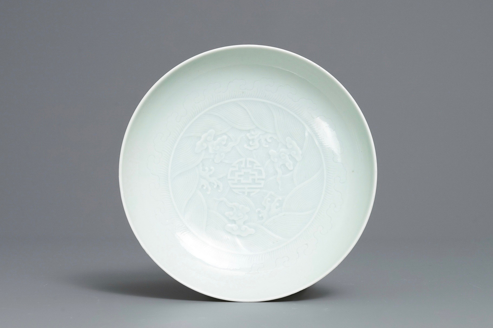 A Chinese celadon saucer dish with underglaze design, Yongzheng mark and poss. of the period