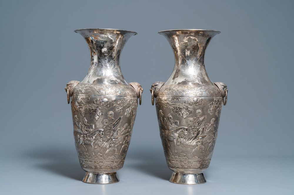 A pair of exceptional large Chinese relief-decorated silver vases, 19th C.