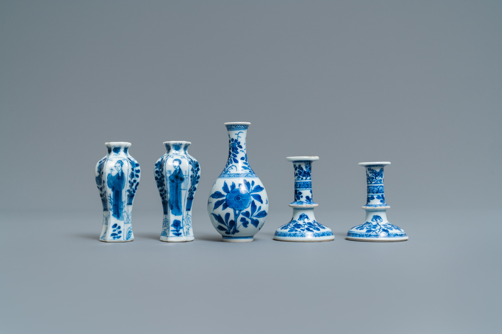 A pair of small Chinese blue and white candlesticks and three vases, Kangxi