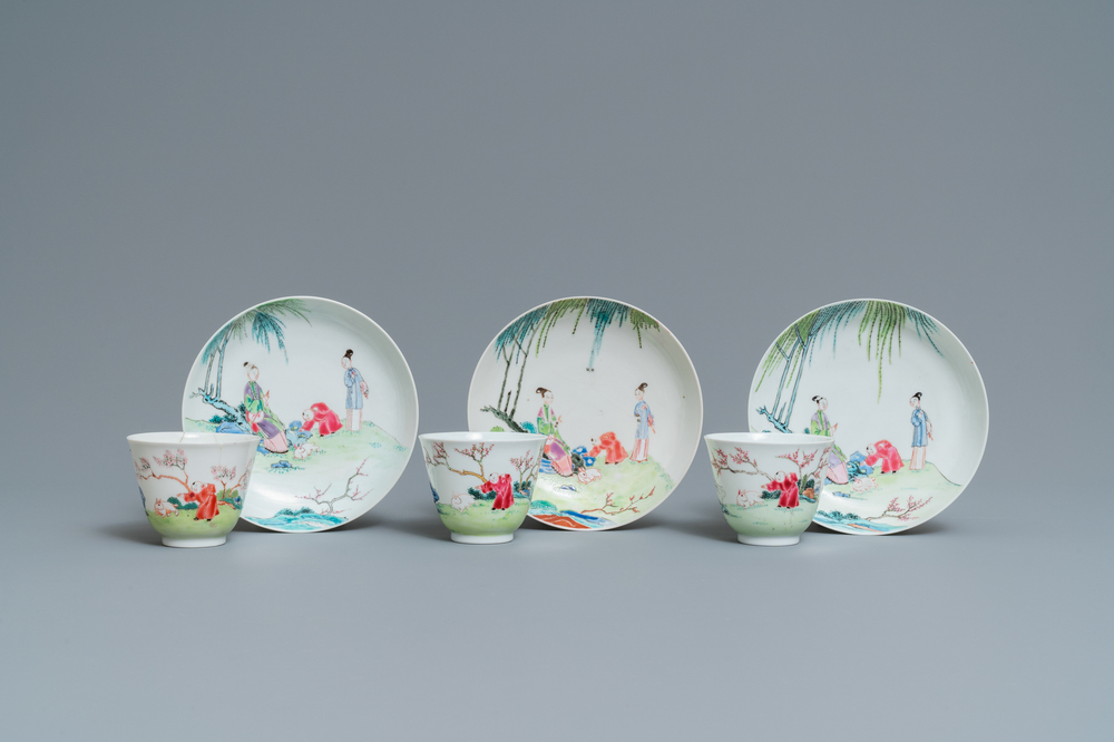 Three Chinese famille rose cups and saucers with figures in a garden, Yongzheng