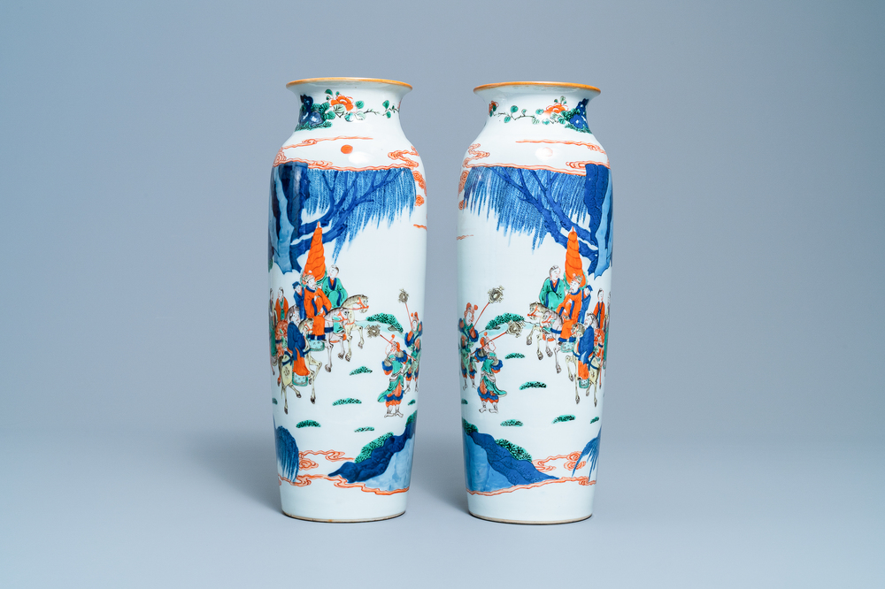 A pair of Chinese wucai rouleau vases with figures on horseback, 19th C.