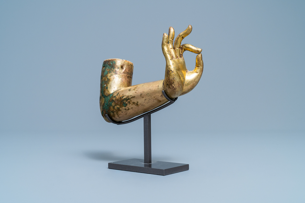 A Tibetan gilt bronze and copper alloy arm of Buddha, Ming