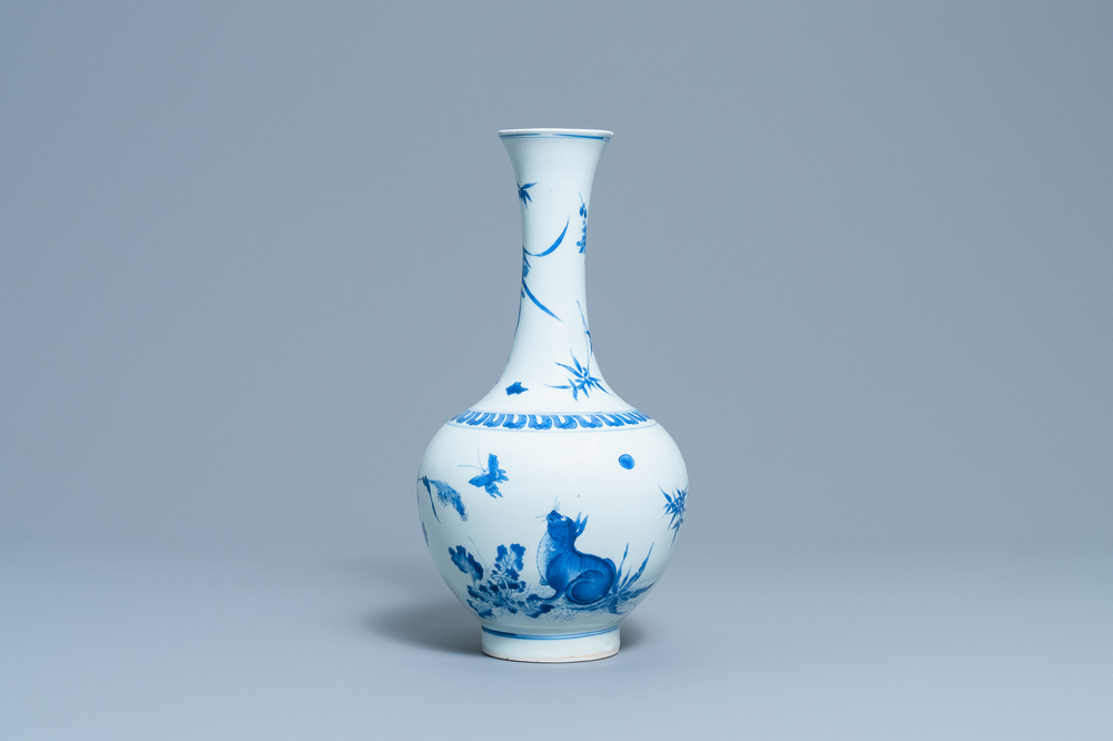 Un vase de forme bouteille en porcelaine de Chine en bleu et blanc &agrave; d&eacute;cor d'un chat et d'un papillon, &eacute;poque Transition