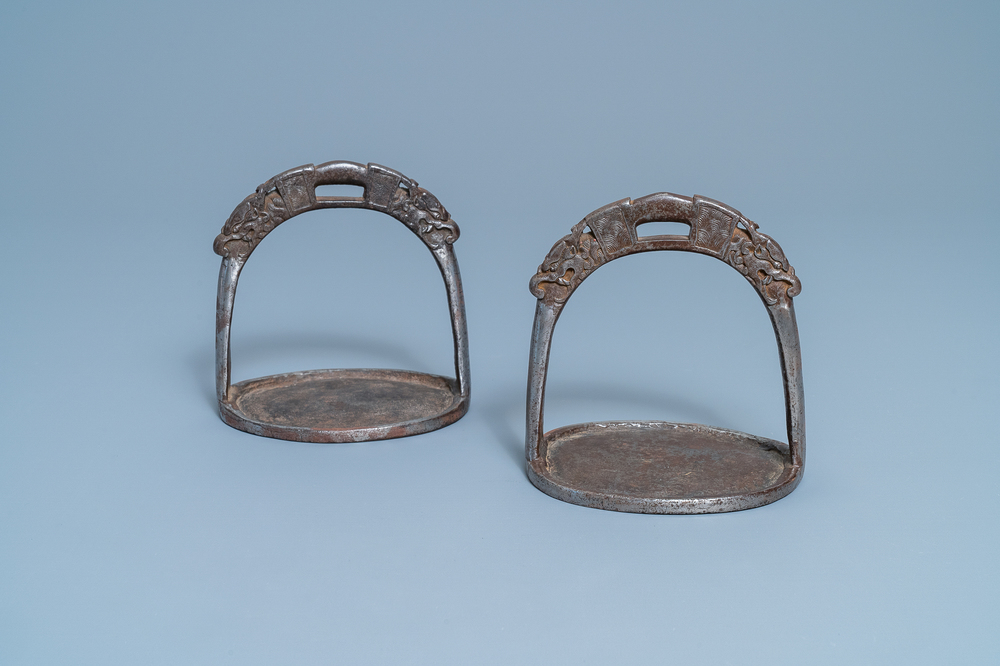 A pair of Tibetan iron stirrups with dragons, 17th C.