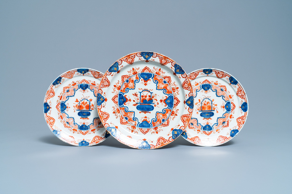 A Dutch Delft dor&eacute; 'flower basket' charger and a pair of plates, early 18th C.